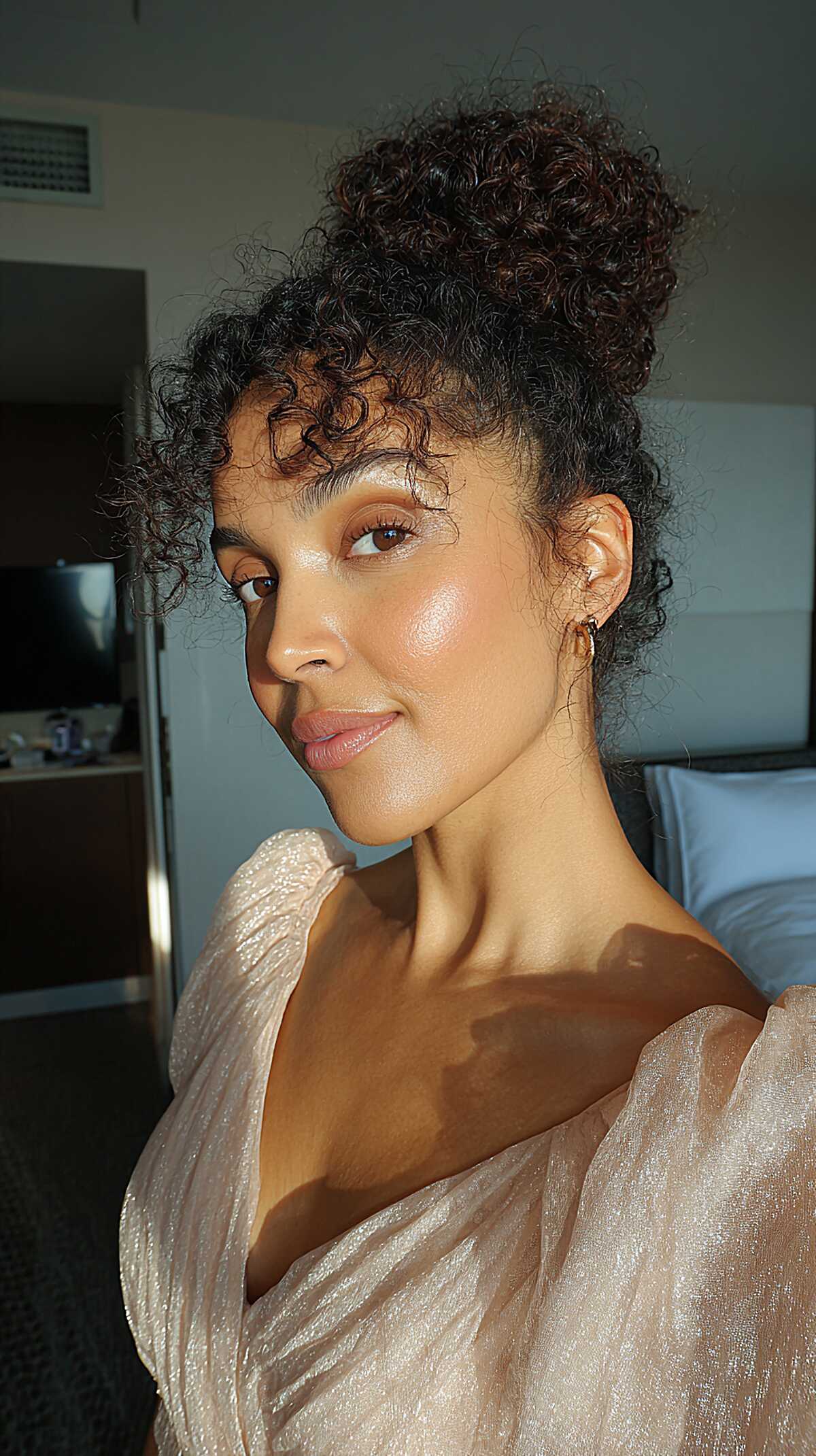 Piled High Curly Topknot with Loose Coil Fringe at the Forehead