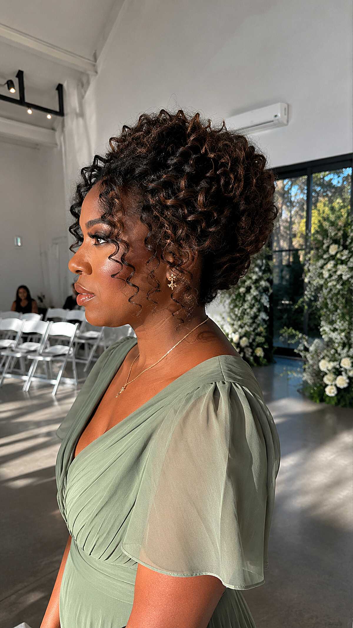 Sculpted Curly Updo with Copper-Kissed Coils and Defined Temple Spirals