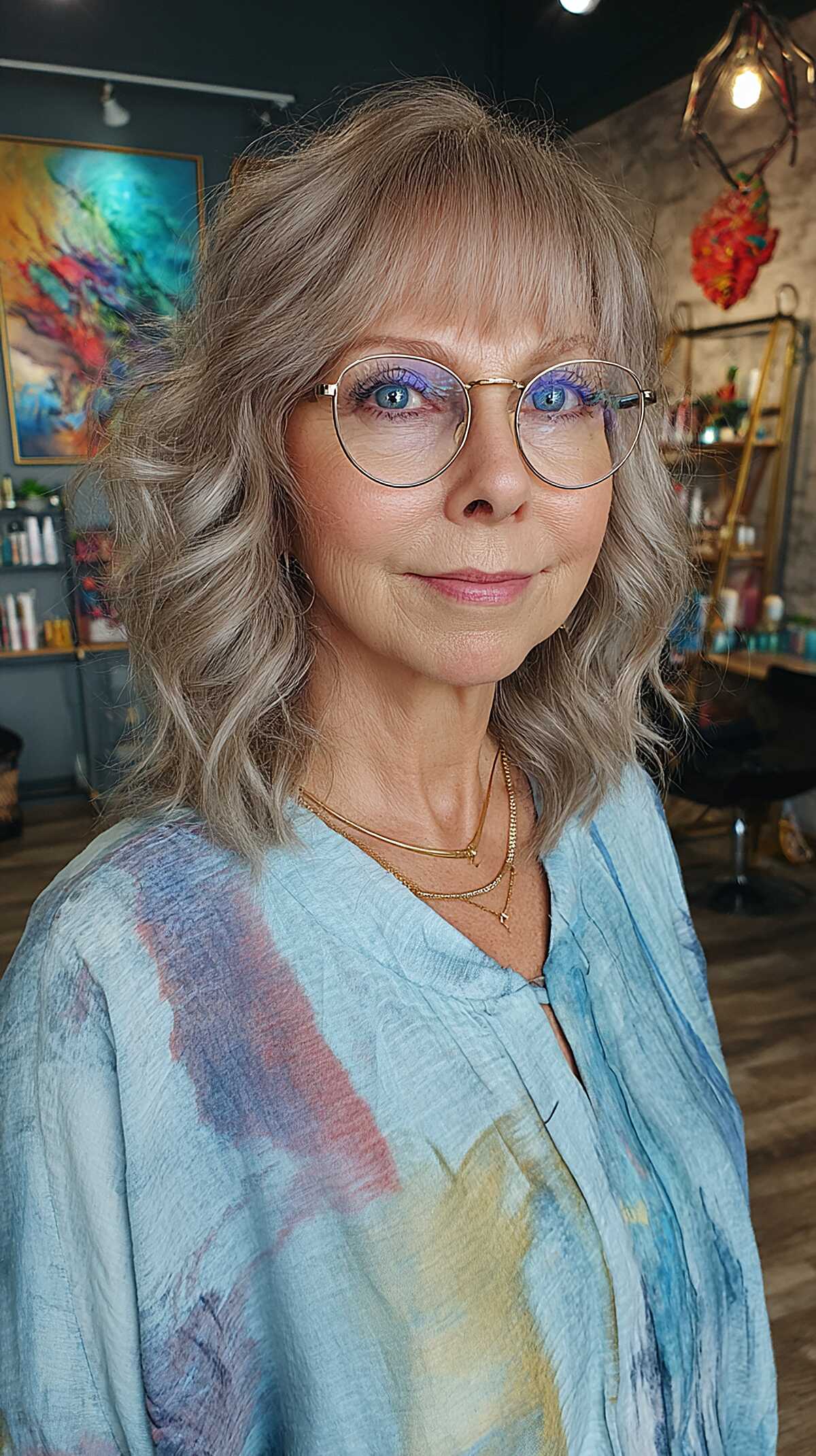 Wavy ash blonde shoulder-length shag with bangs