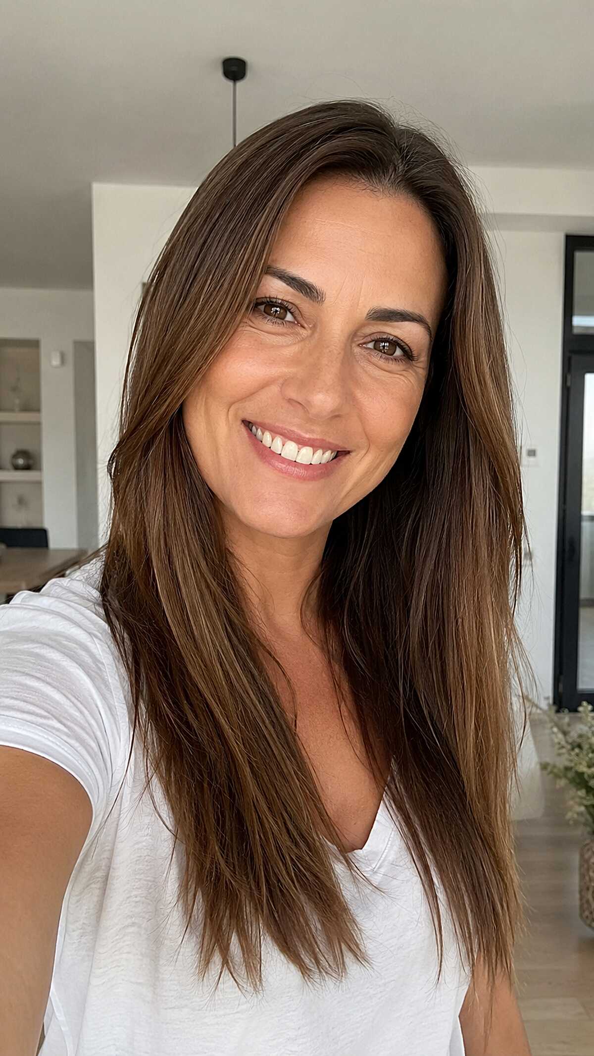 Natural Brunette Long Layers with Subtle Sun Lightening