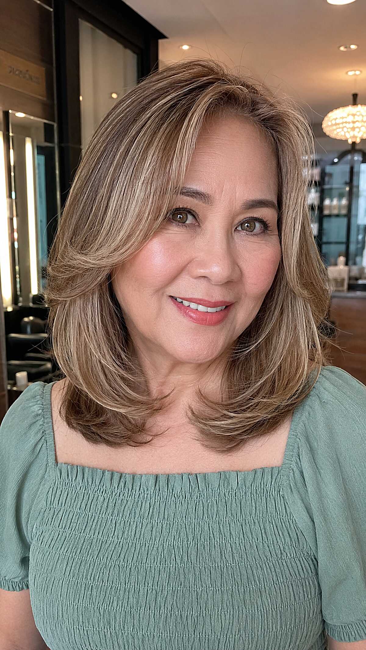 Sandy blonde medium layered cut with curtain framing