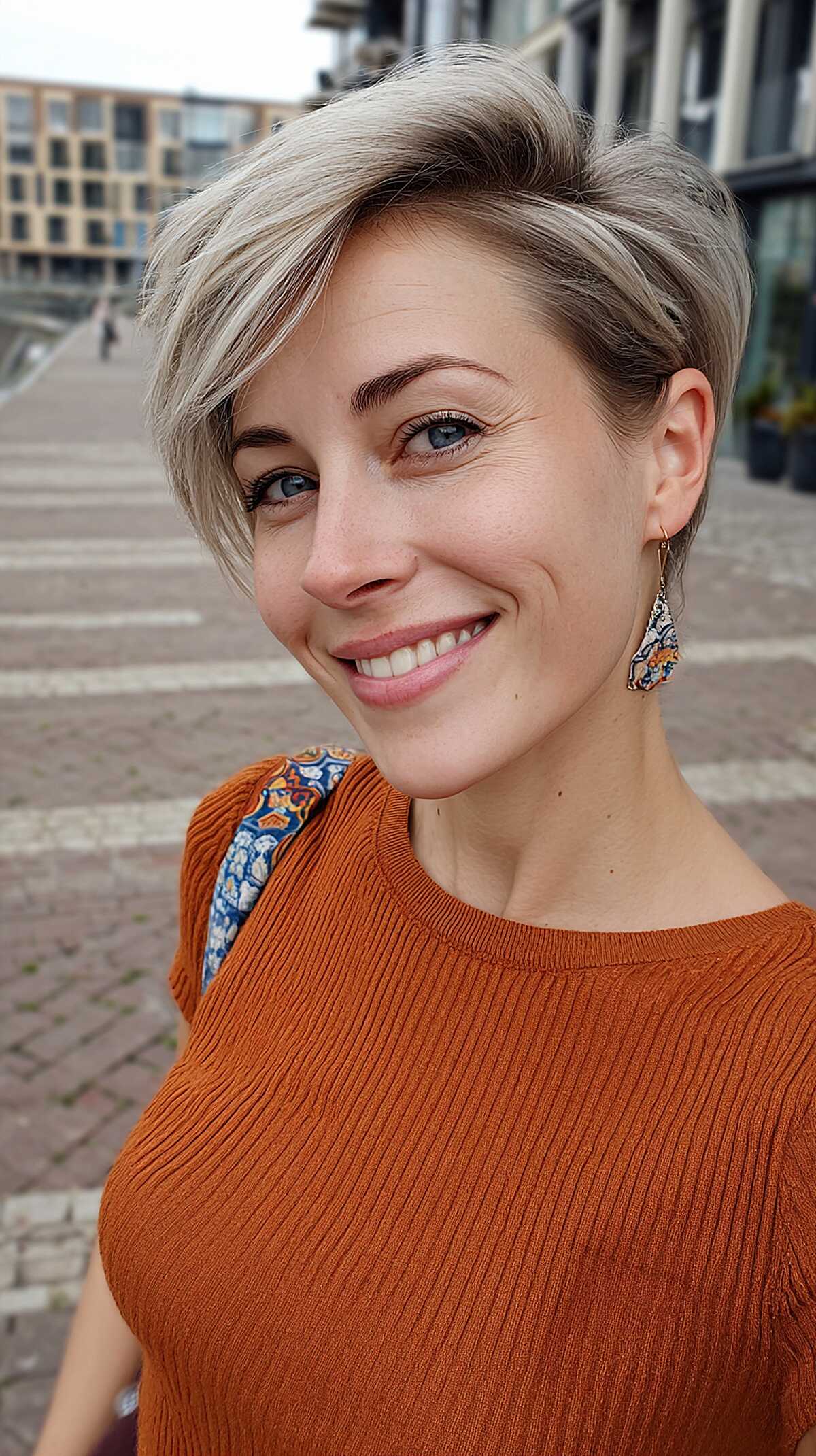Ash Blonde Tapered Pixie with Deep Side Part and Natural Root Blend