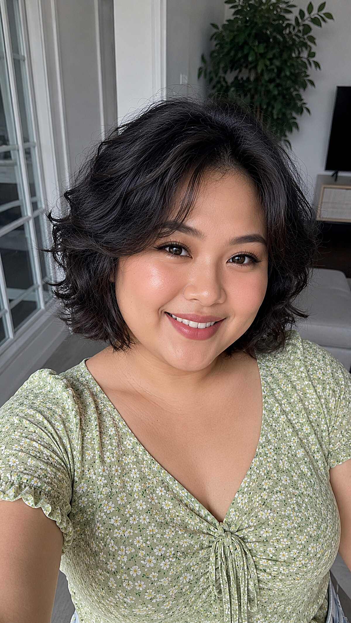 Wavy black chin-length bob with side-swept volume