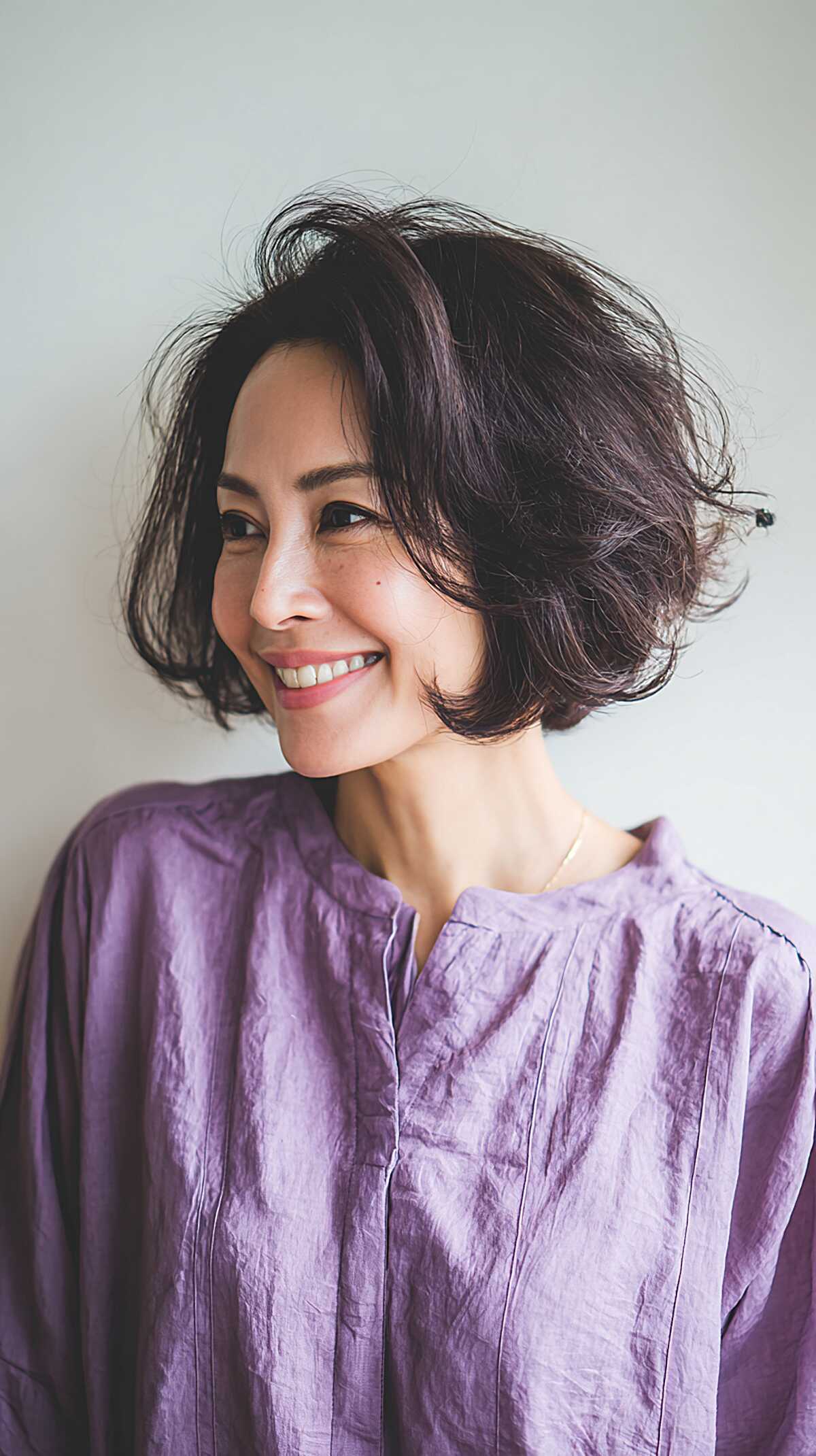 Dark Brunette Chin-Length Bob with Windswept Feathered Movement