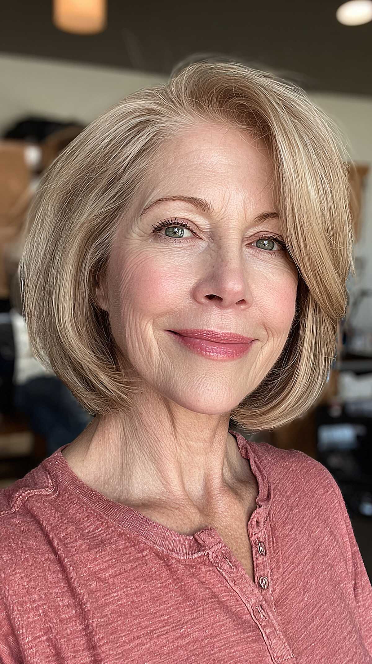 Polished strawberry blonde jaw-length bob with side part