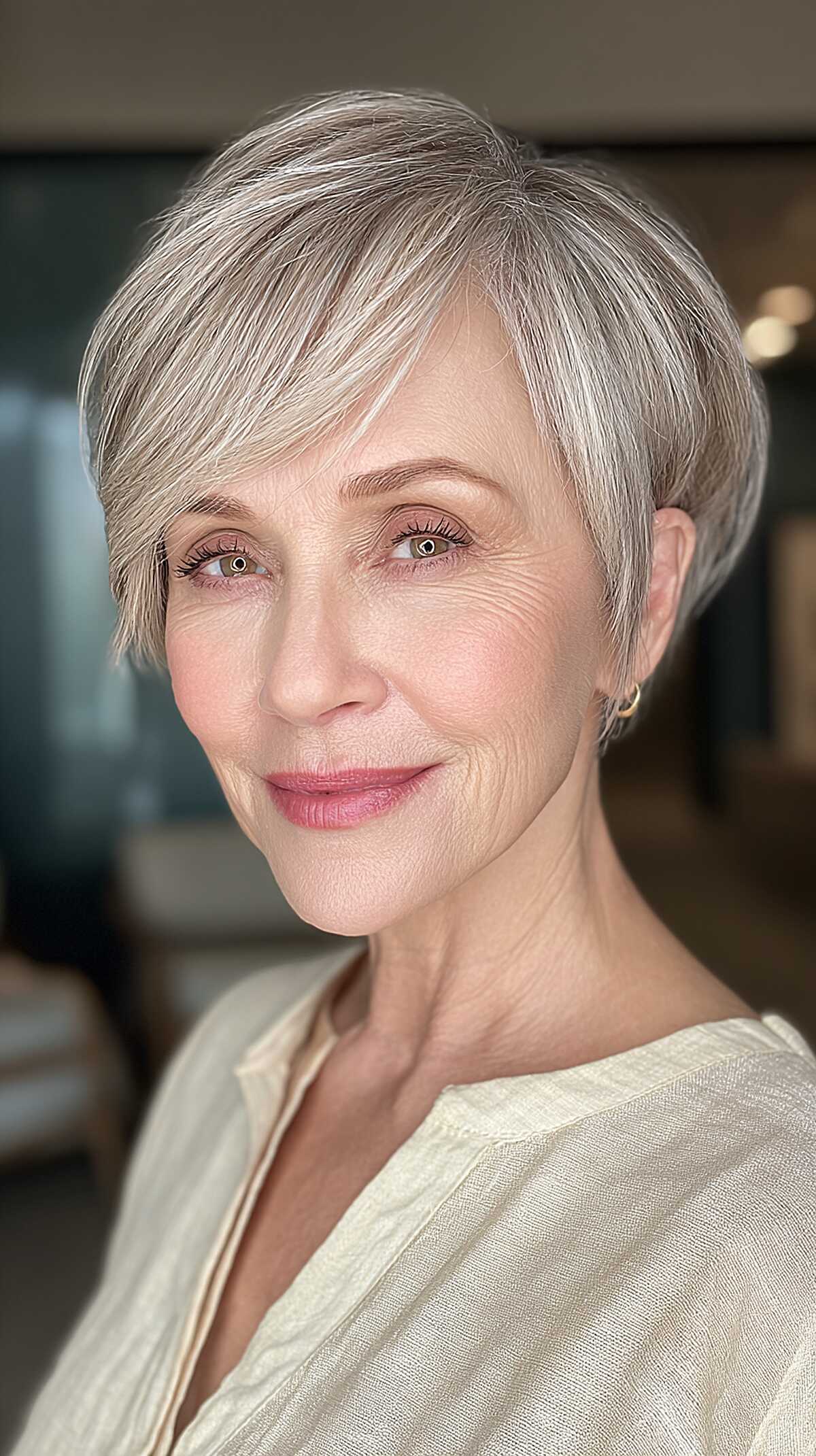 Refined side-swept pixie in ash blonde on woman over 60