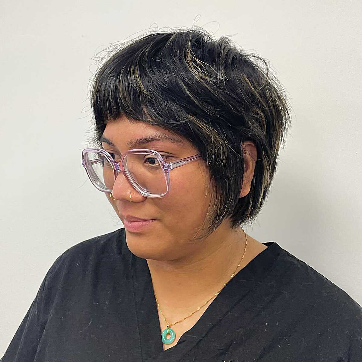 Black shaggy bixie with golden highlights and glasses