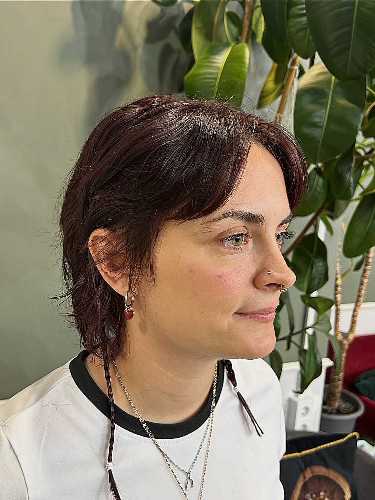 Burgundy bixie with side-swept bangs and braided tails