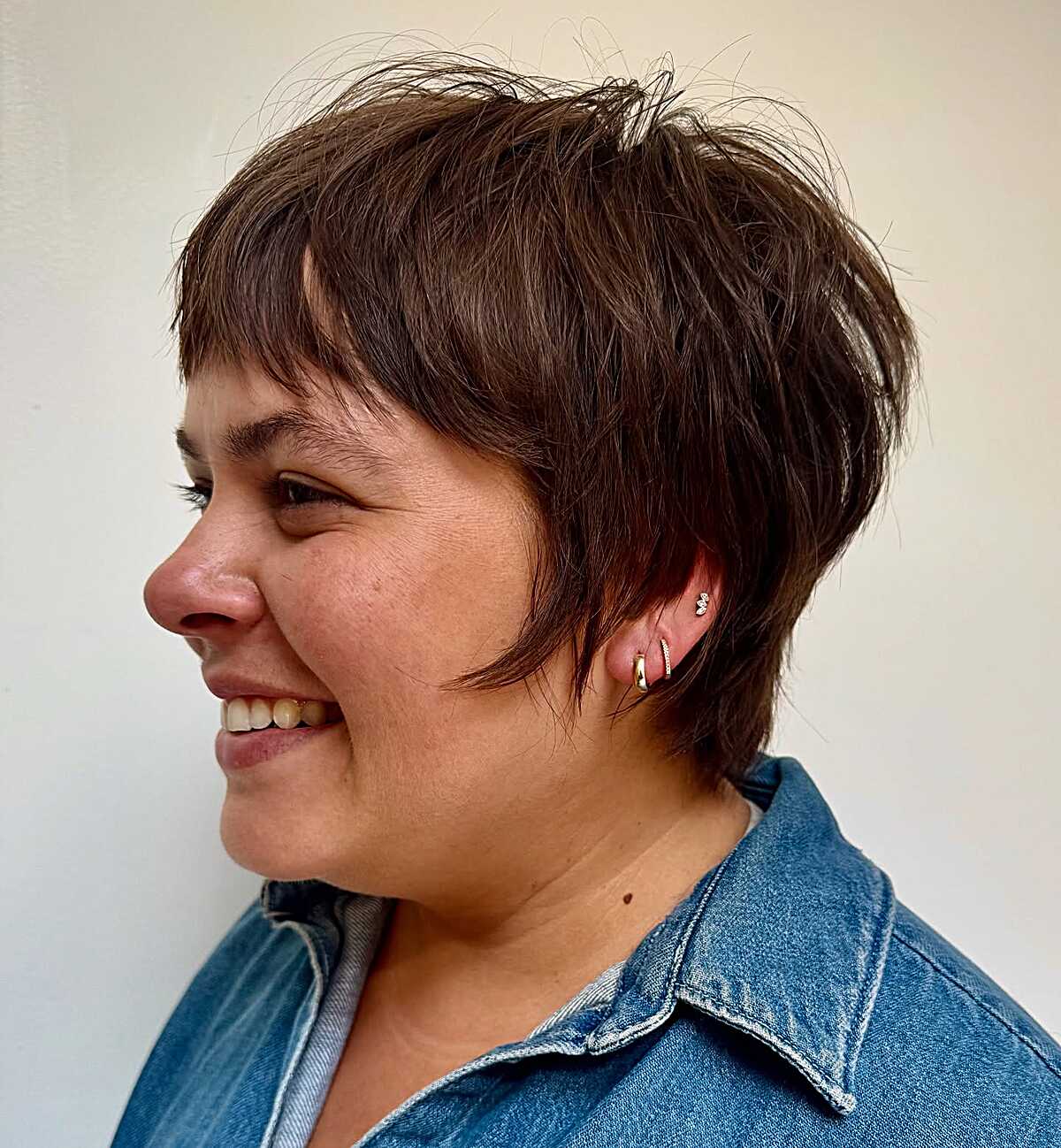 Short choppy brunette bixie with textured top and bangs