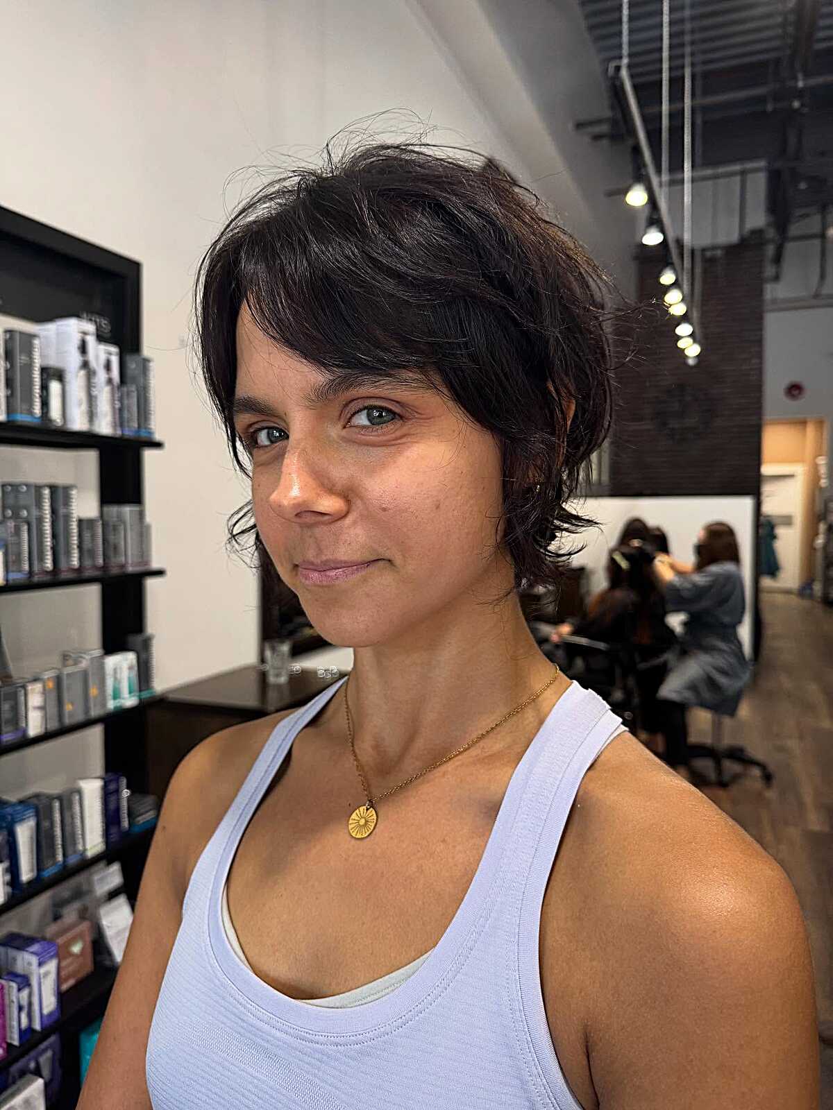 Tousled dark bixie at pixie length with soft waves