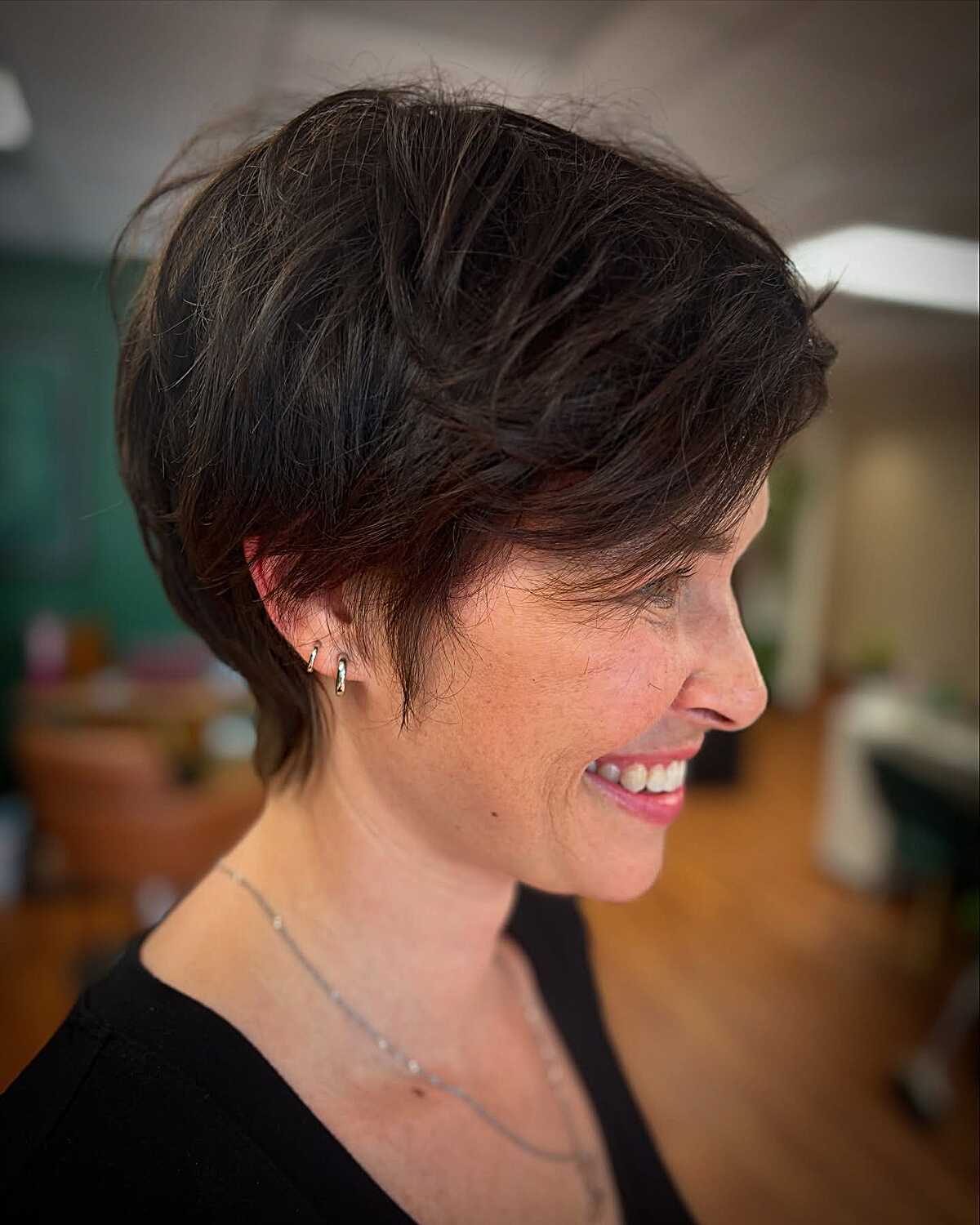 Voluminous dark bixie with side-swept layers and body