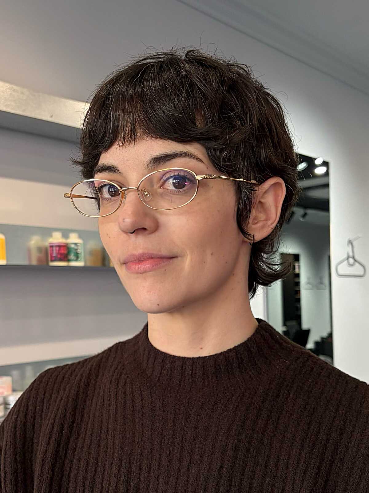 Short wavy brunette bixie with baby bangs and glasses
