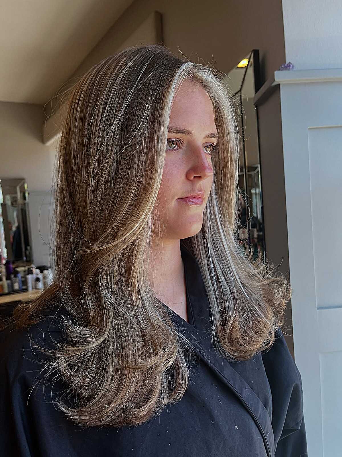 Long brown hair with blonde face-framing highlights