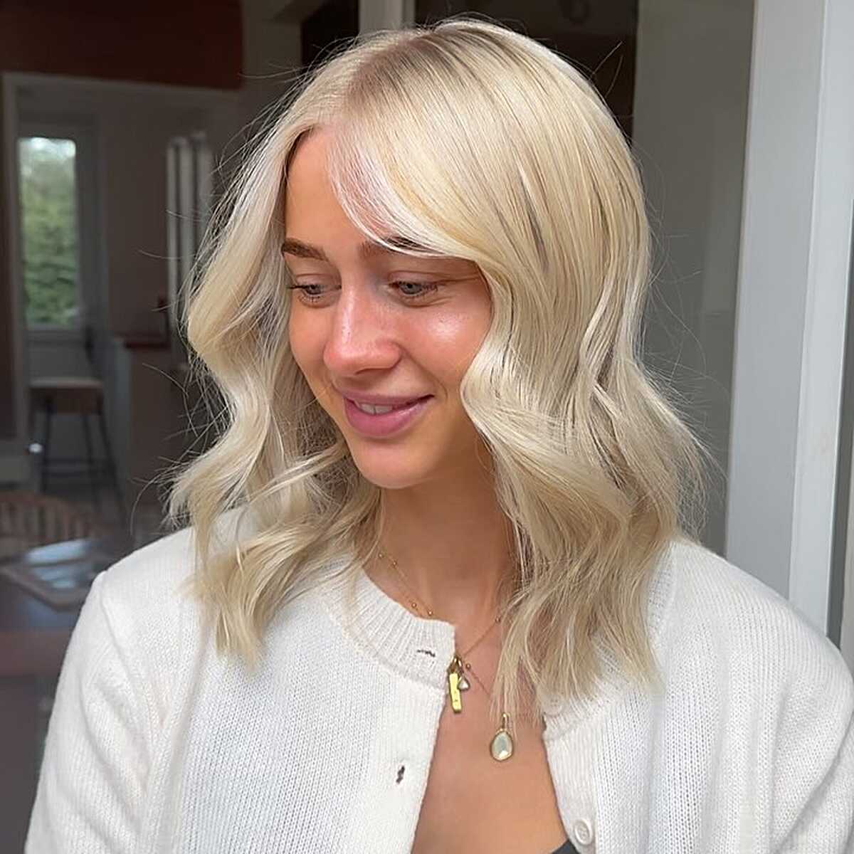 Creamy vanilla blonde wavy bob with soft layers