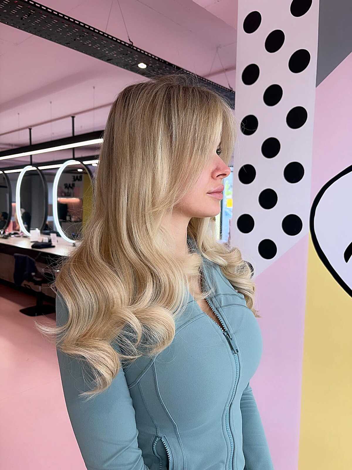 Long honey blonde layers with side-swept fringe