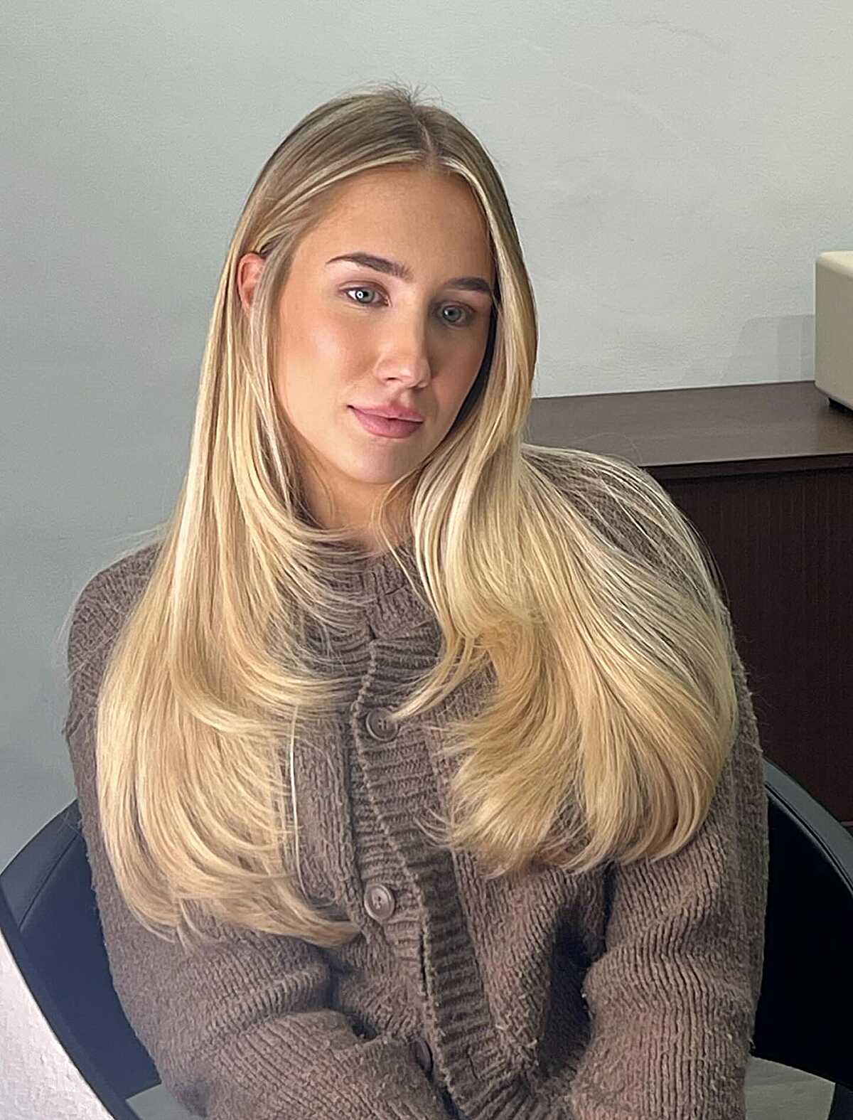 Long sandy blonde straight hair with subtle face framing