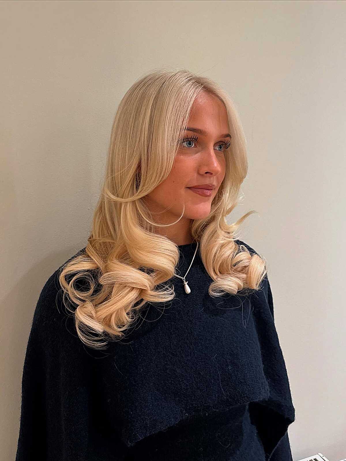 Peach-toned blonde with vintage curled layered ends
