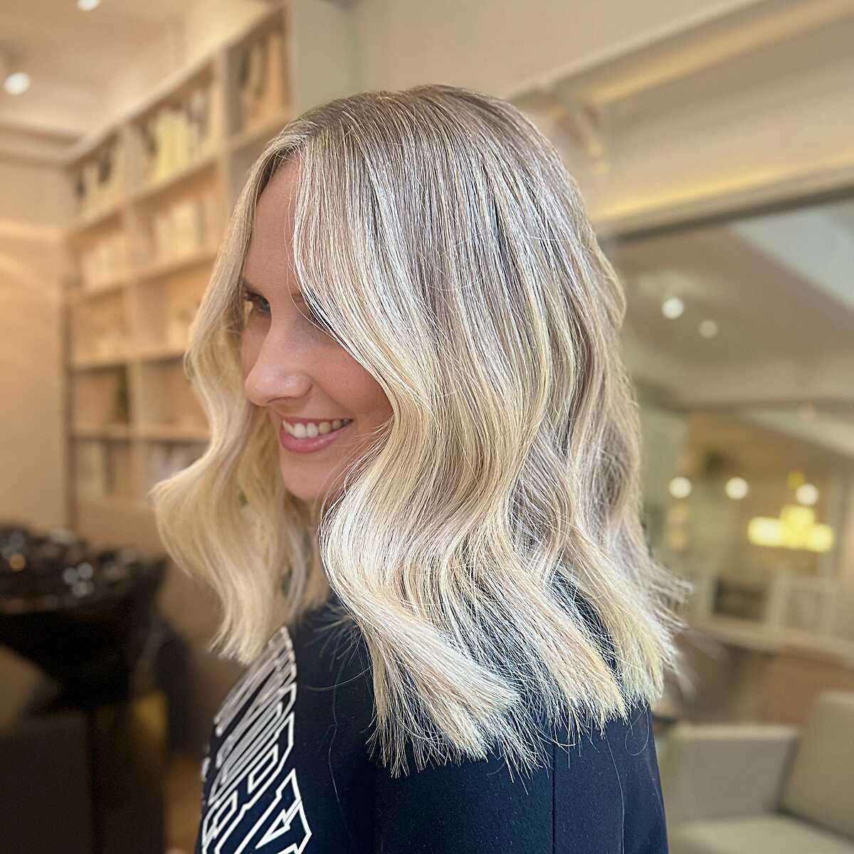 Rooted blonde lob with soft wavy movement