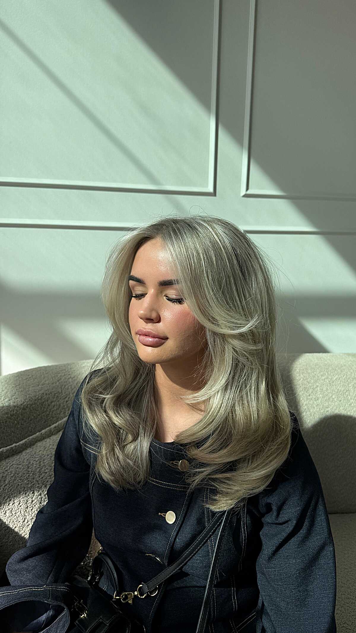 Smoky silver blonde hair with voluminous layered styling