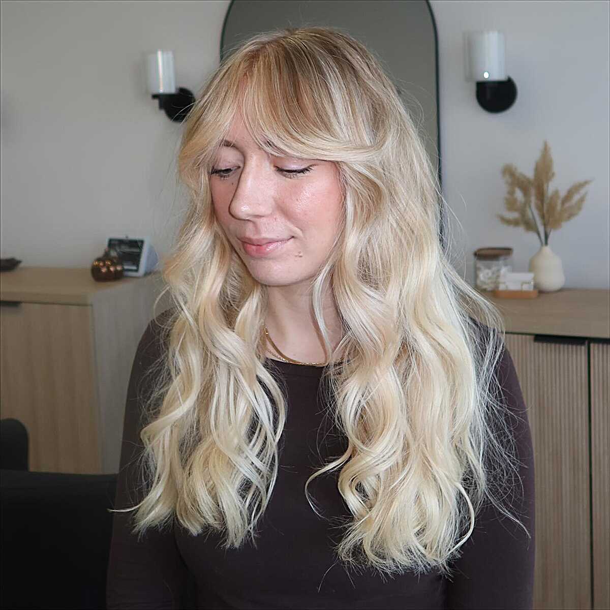 Long warm blonde shag with wispy bangs and loose waves