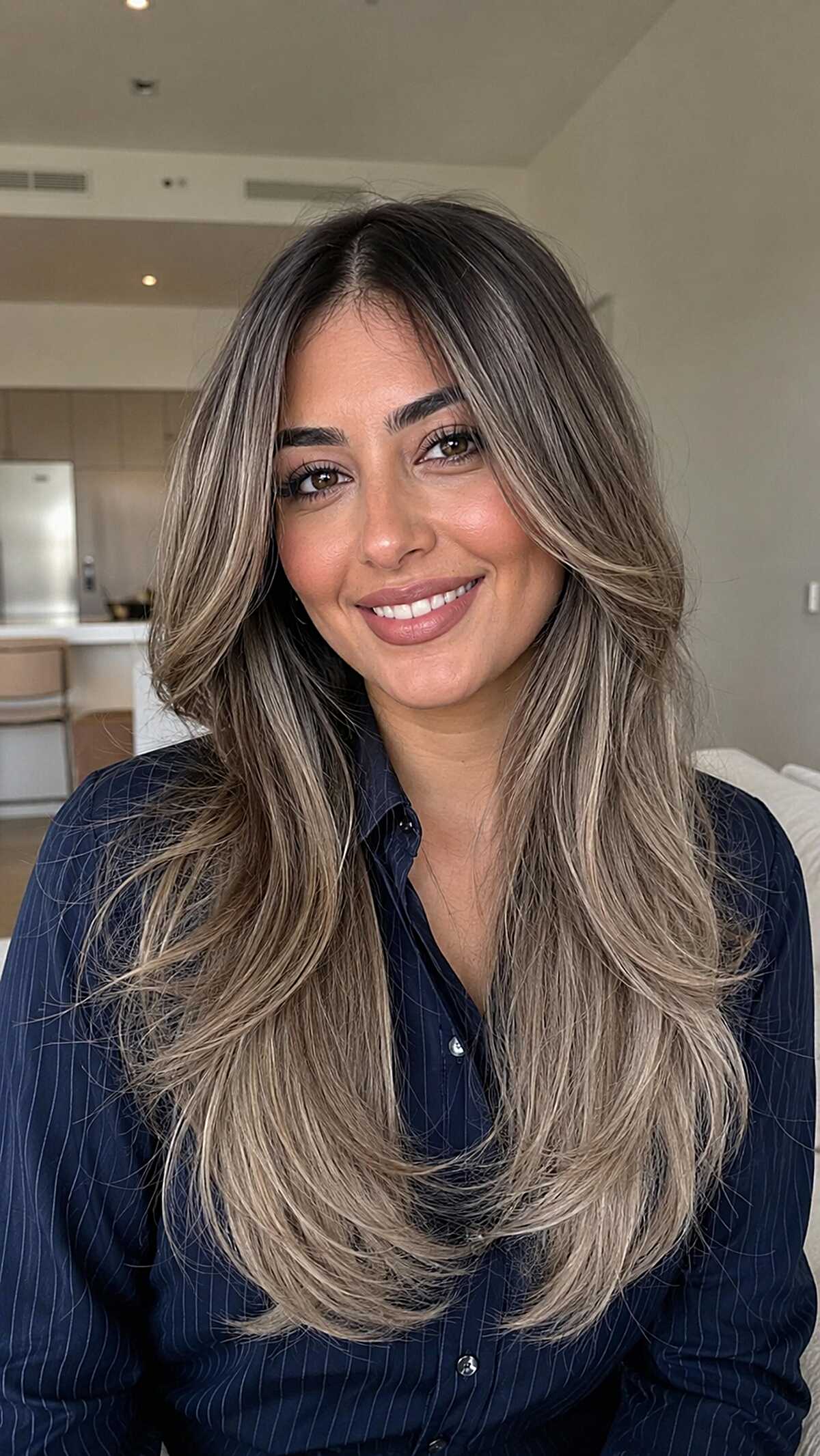 Smoky Ash Blonde Balayage on Long Layers with a Deep Brunette Root on Olive Skin