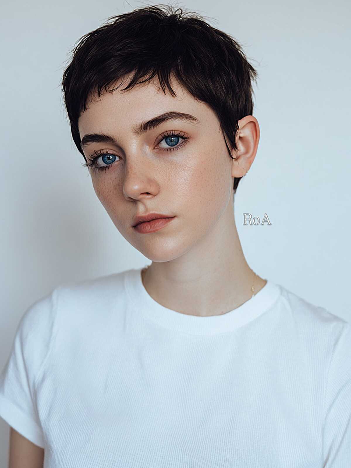 Very short dark brunette pixie with micro fringe