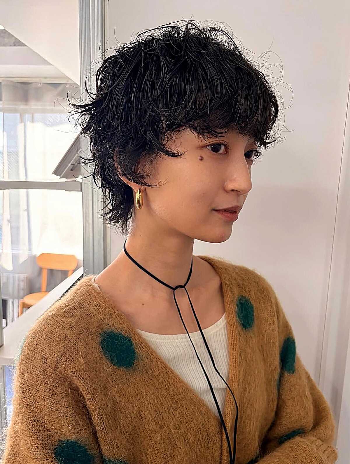 Short curly black shag with bangs and textured layers