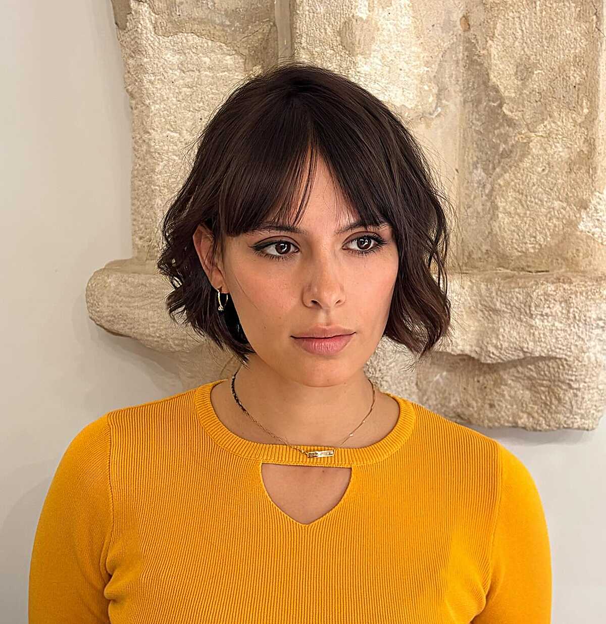 Wavy dark brunette bob with soft curtain bangs
