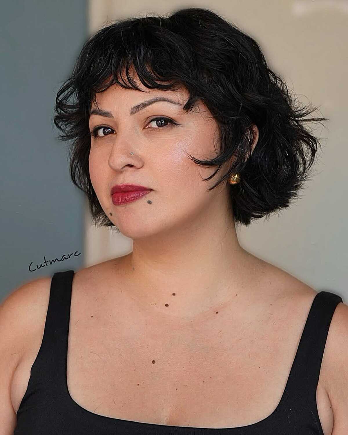 Jet black chin-length wavy bob shag with red lipstick