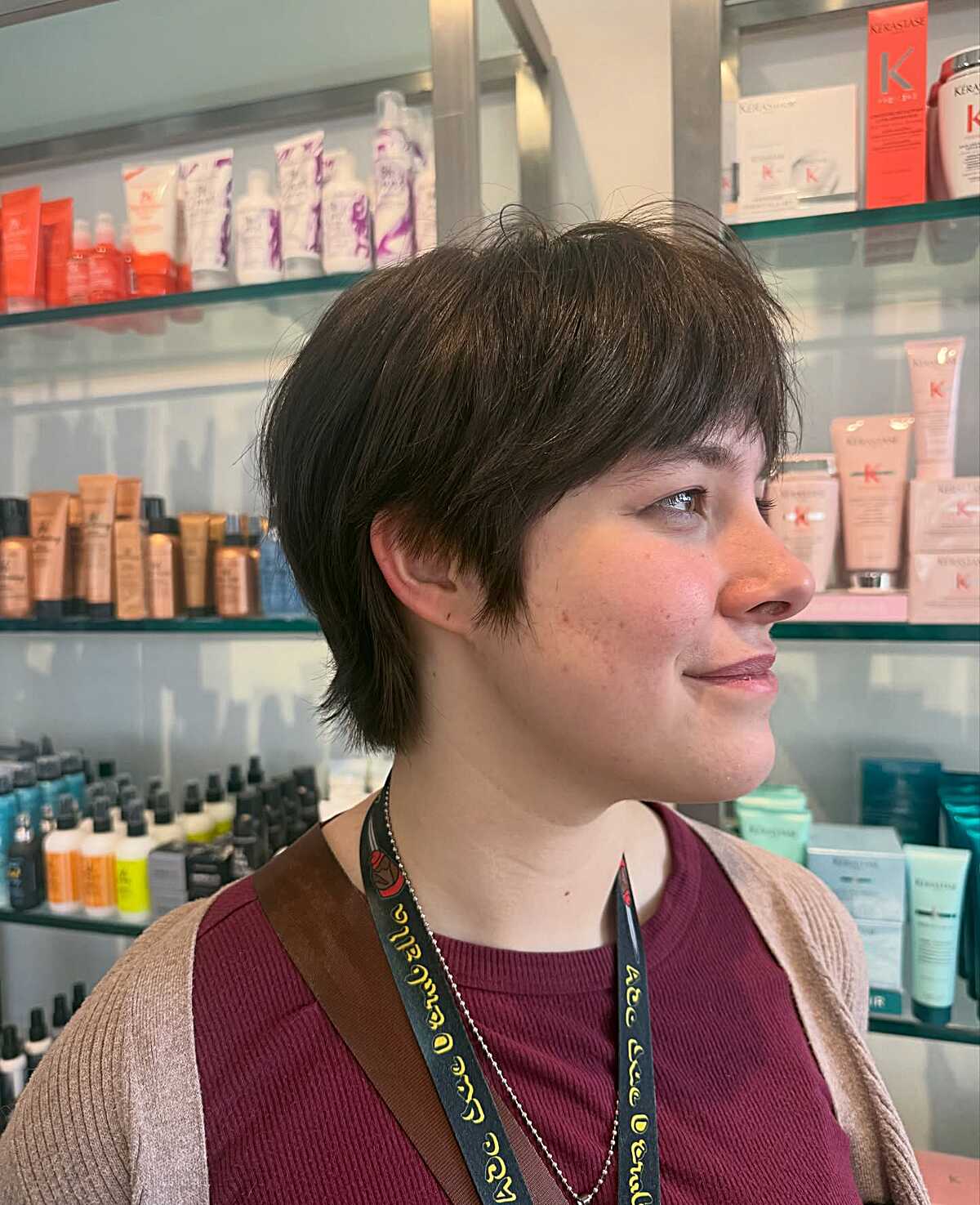Layered dark brunette pixie bob with side-swept fringe