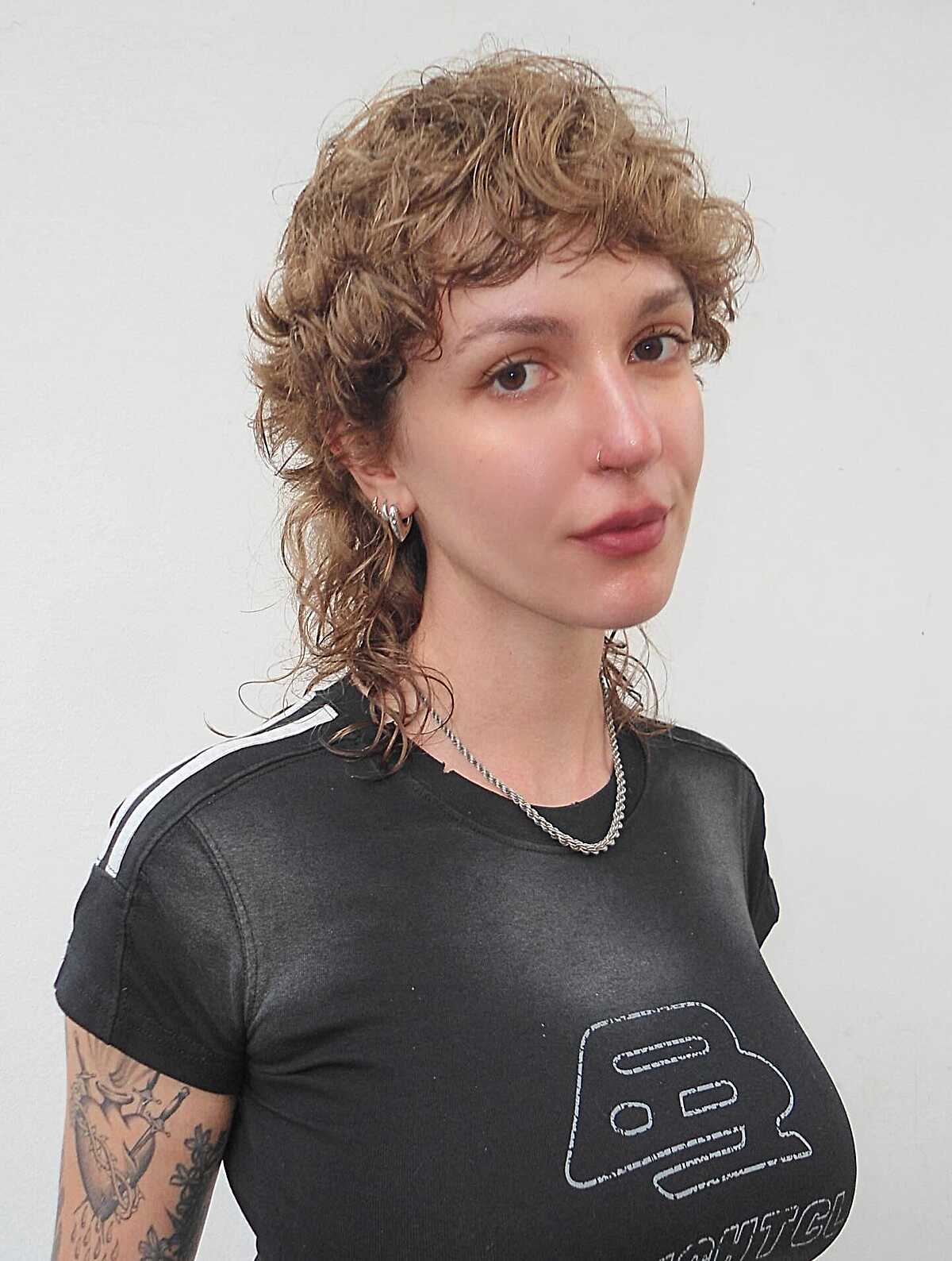 Sandy blonde curly short shag with short bangs