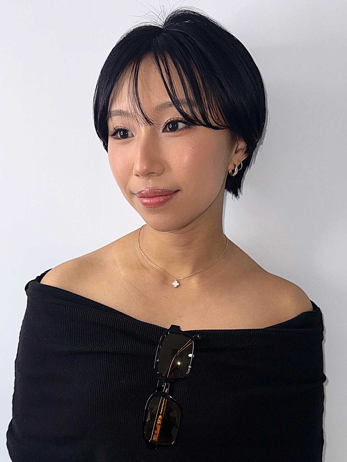 Sleek black pixie bob with wispy side-swept bangs