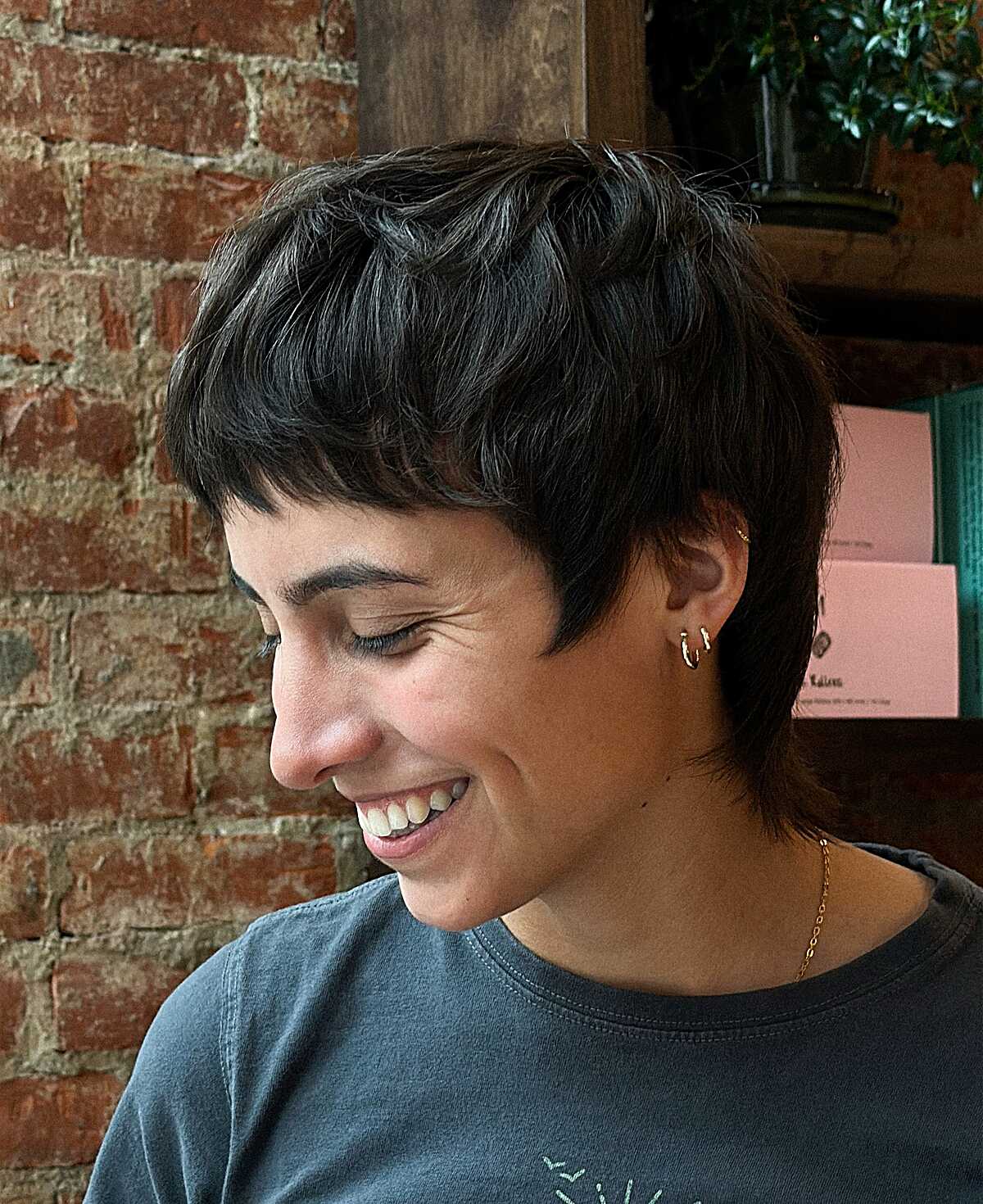 Textured dark brunette pixie cut with wispy fringe