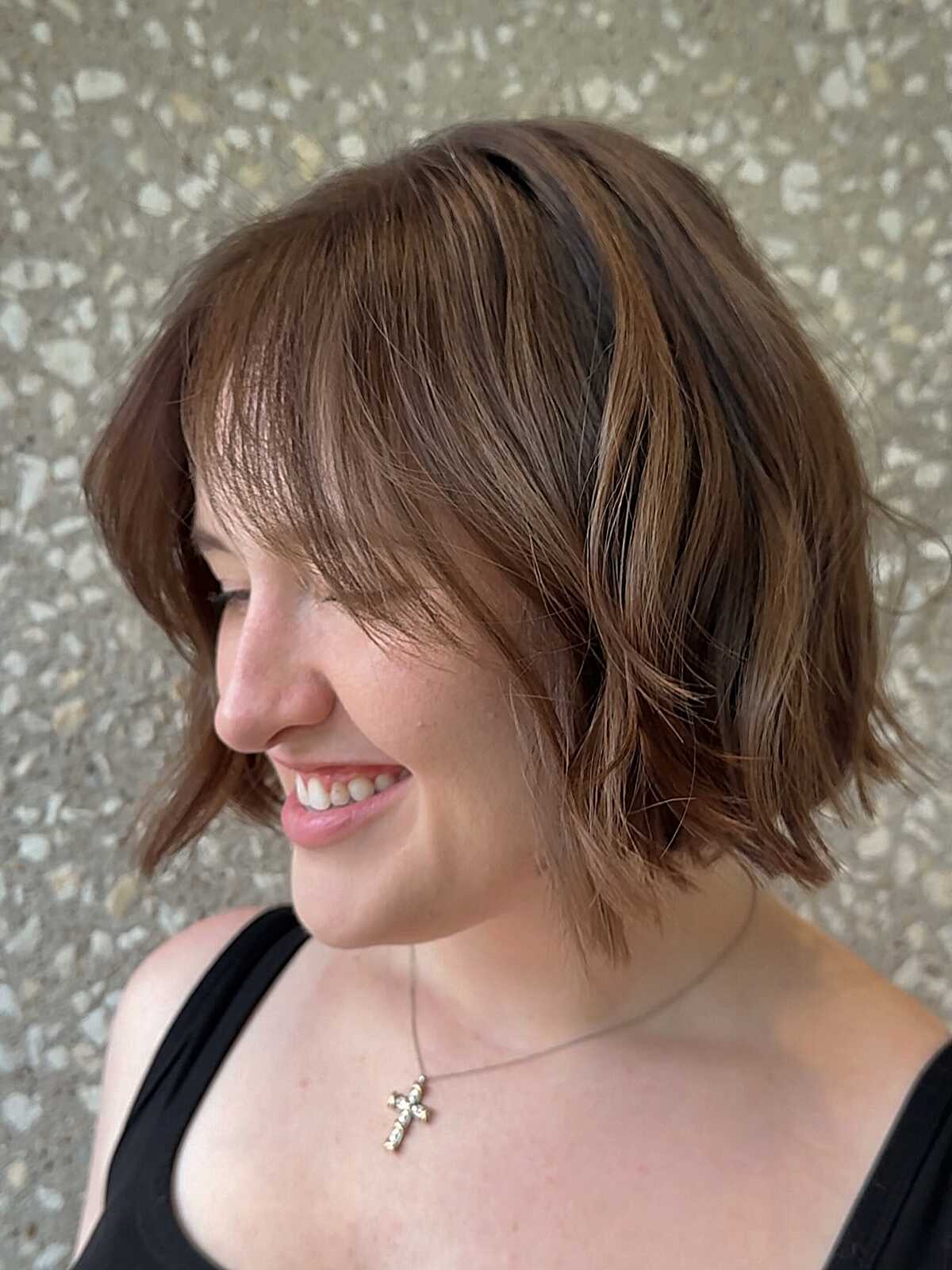 Wavy brunette chin-length bob with soft light bangs