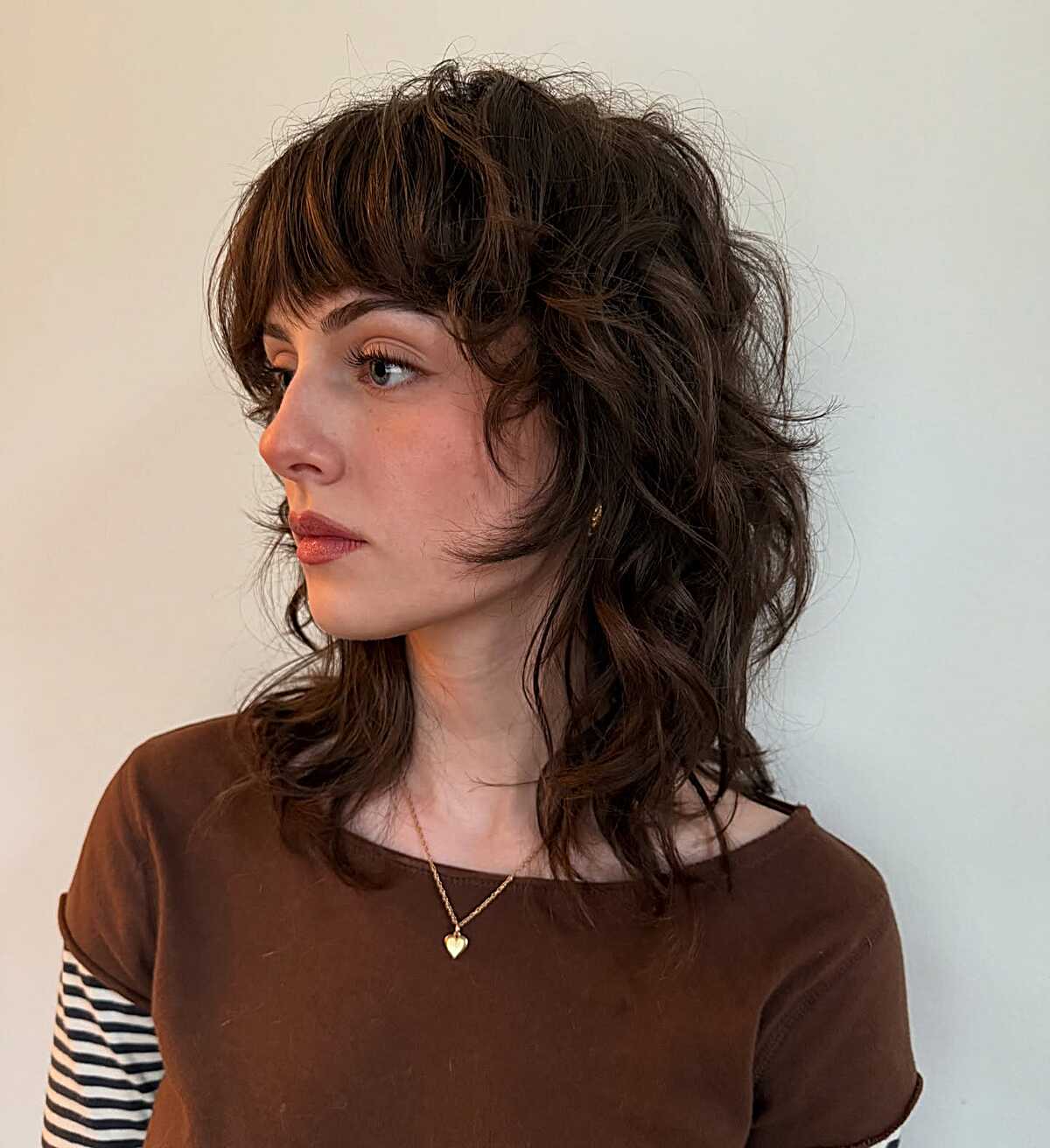 Dark chocolate shoulder-length shag with piecey bangs