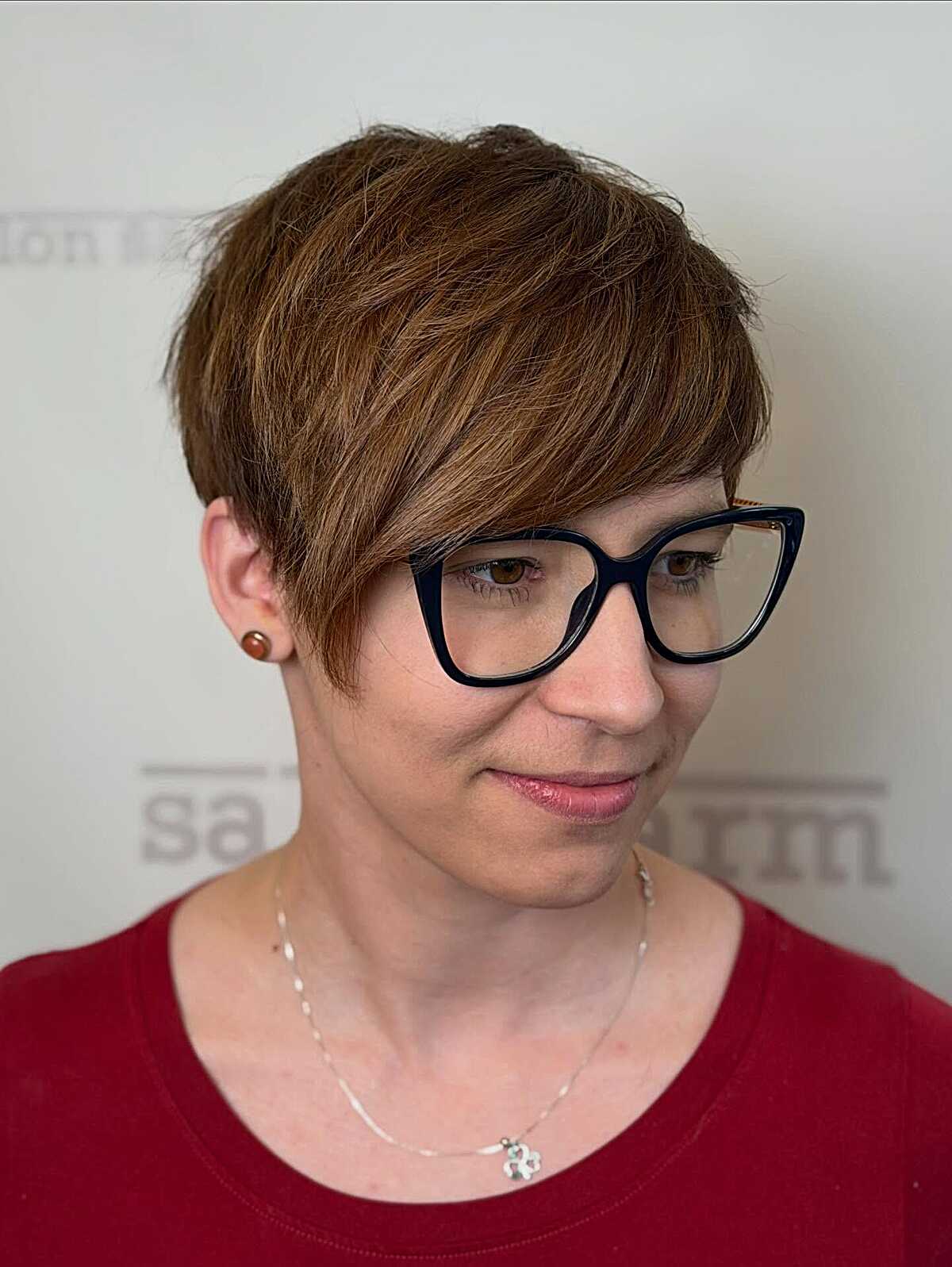 Feathered warm auburn pixie cut with side-swept bangs