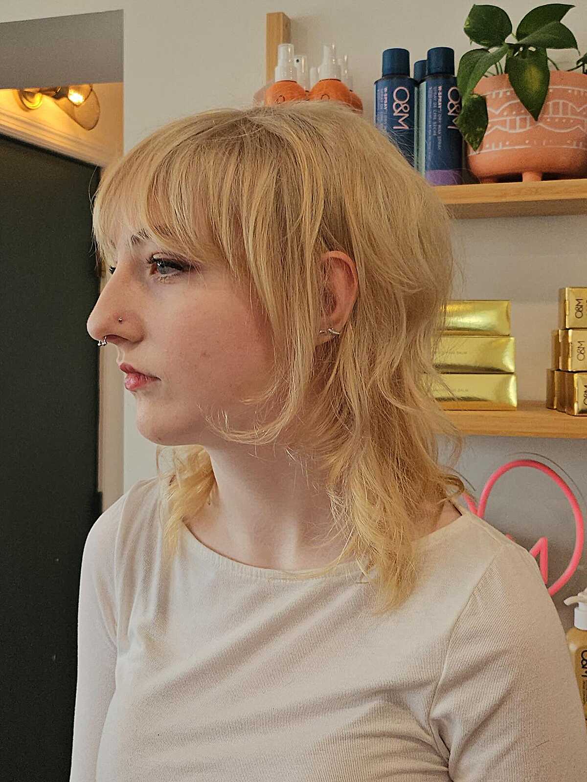 Warm blonde medium shag with choppy micro bangs