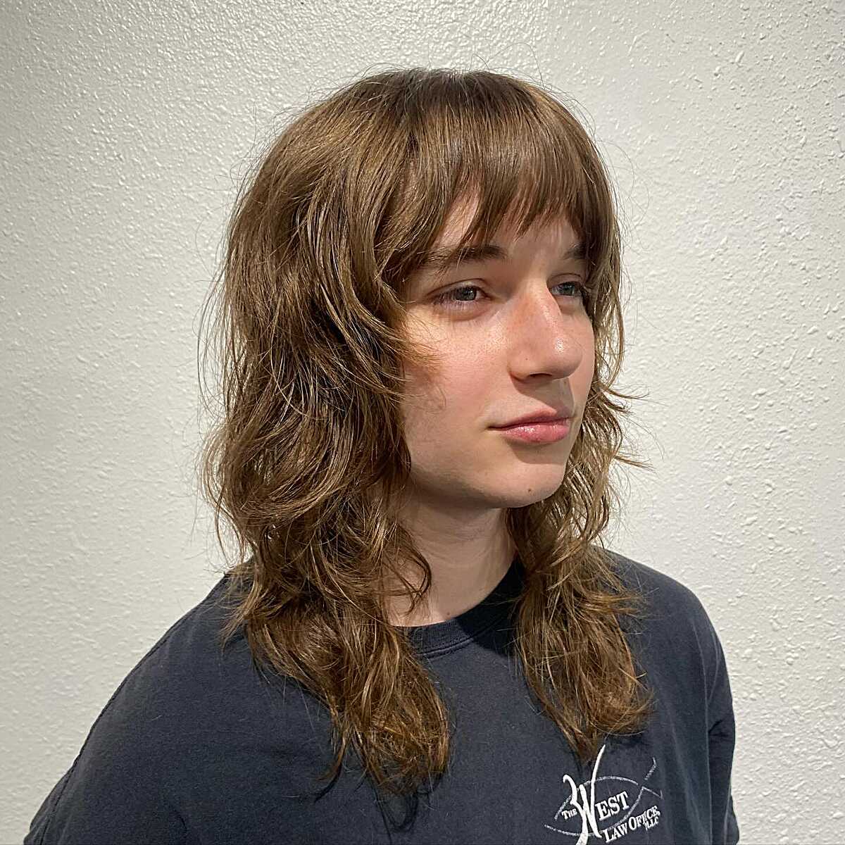 Medium-length wavy brunette shag with curtain bangs