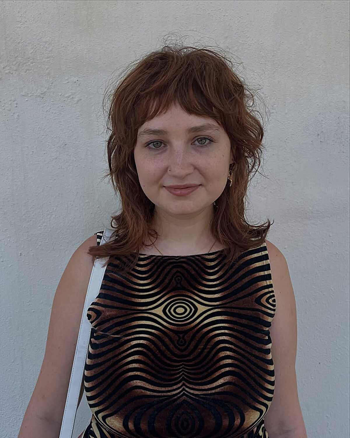 Medium wavy auburn shag with a soft center part