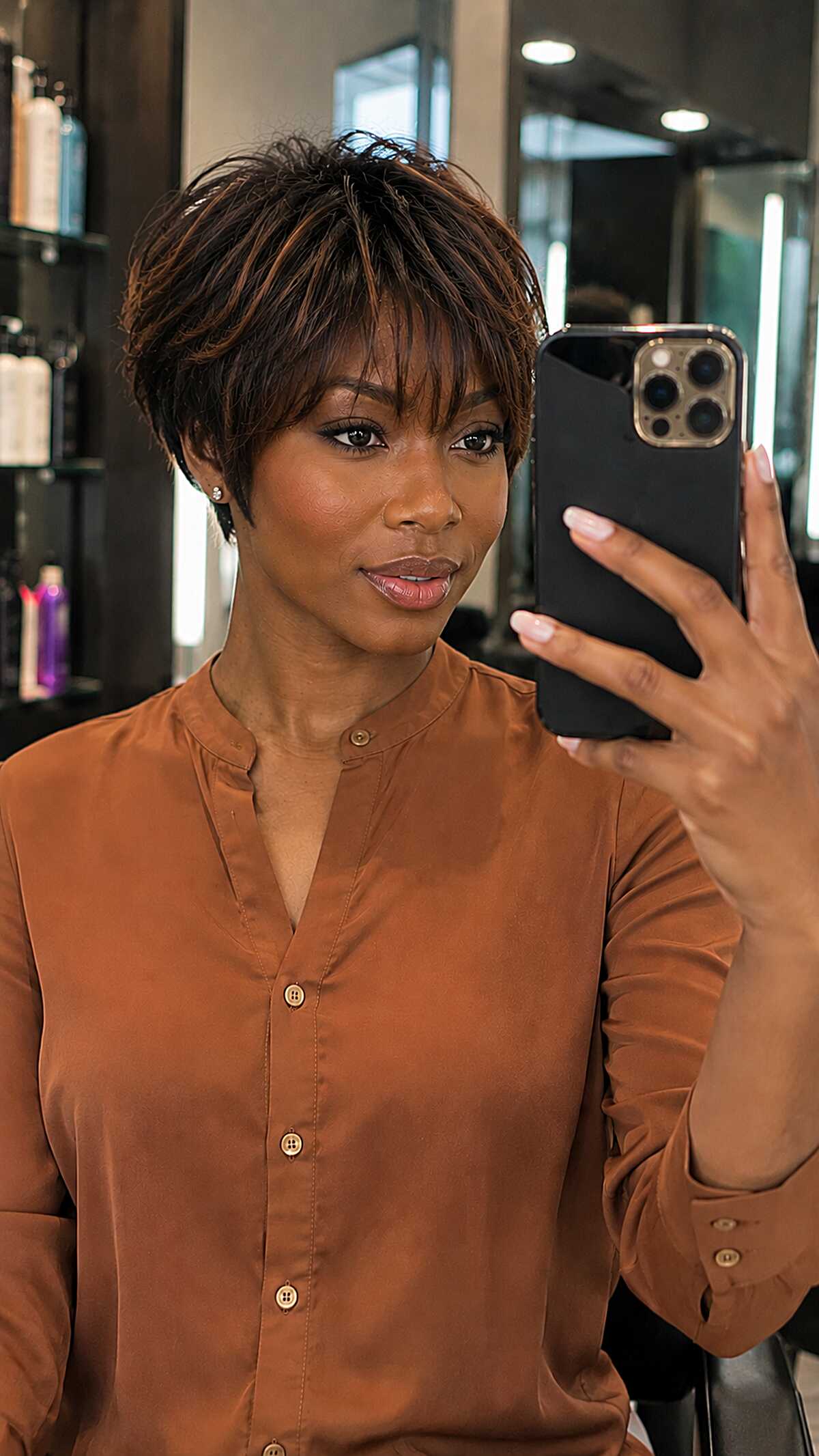 Textured dark brown bixie with bangs, salon mirror selfie