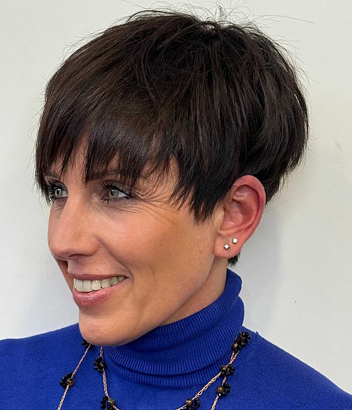 Dark espresso piecey pixie with fringe on older woman