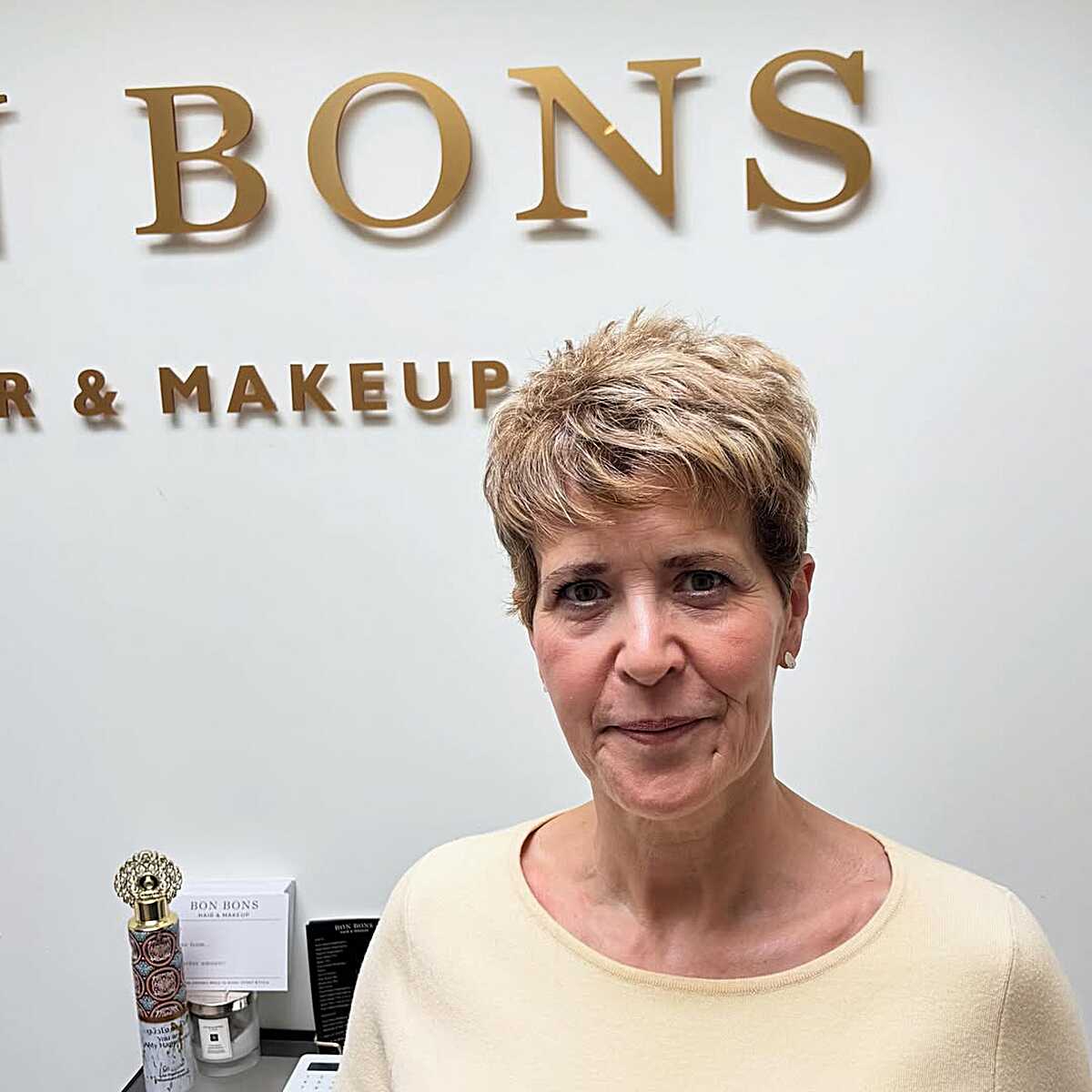 Honey blonde textured short pixie on mature woman