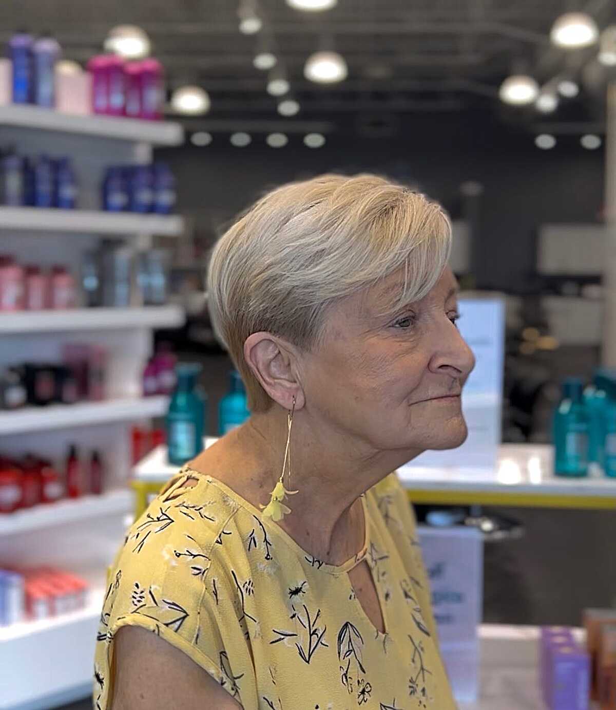 Platinum blonde pixie with side part and tapered nape