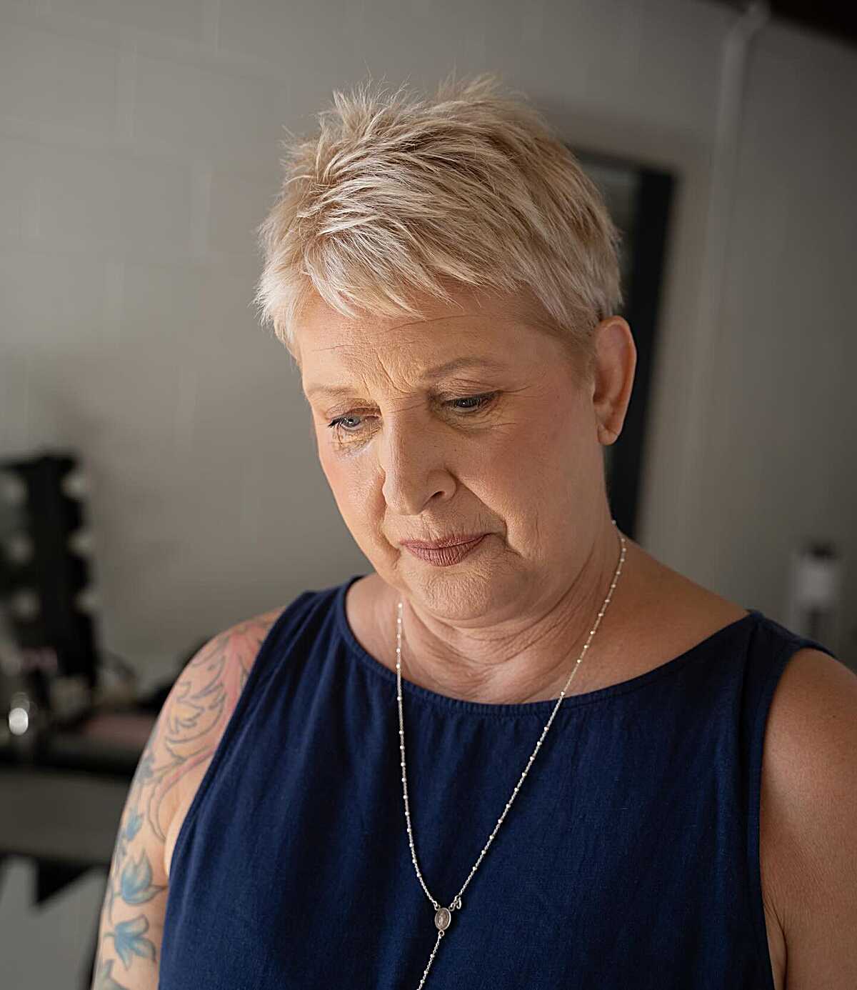 Platinum blonde piecey textured pixie on older woman
