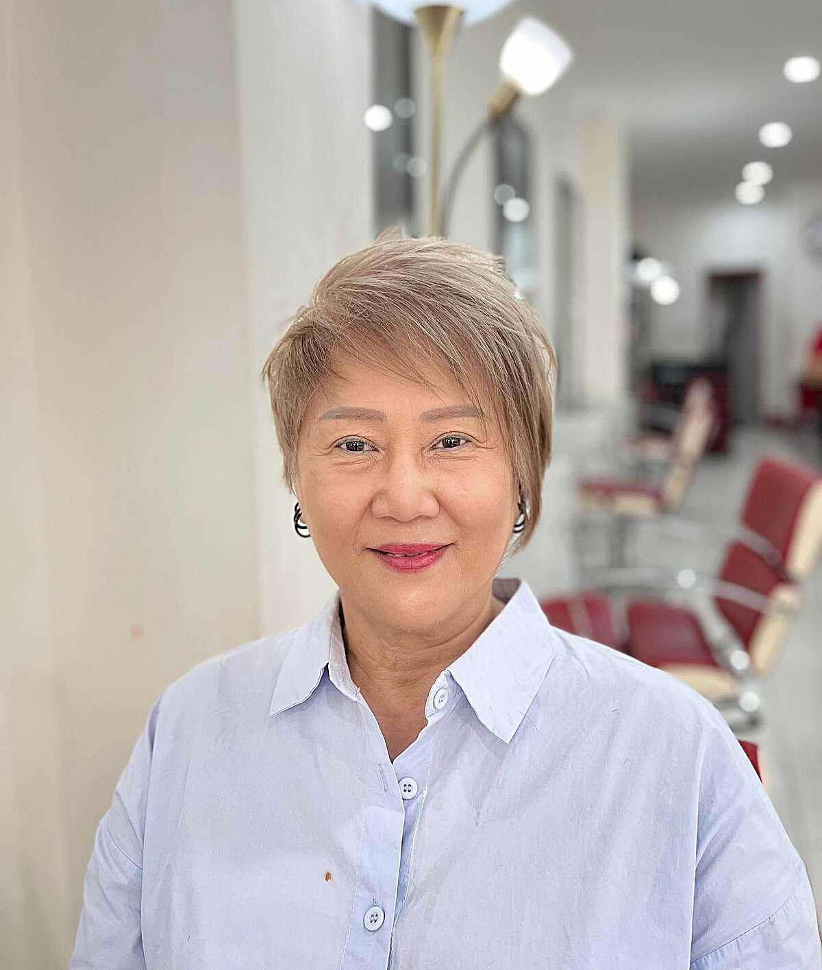 Soft ash blonde tapered pixie on smiling older woman
