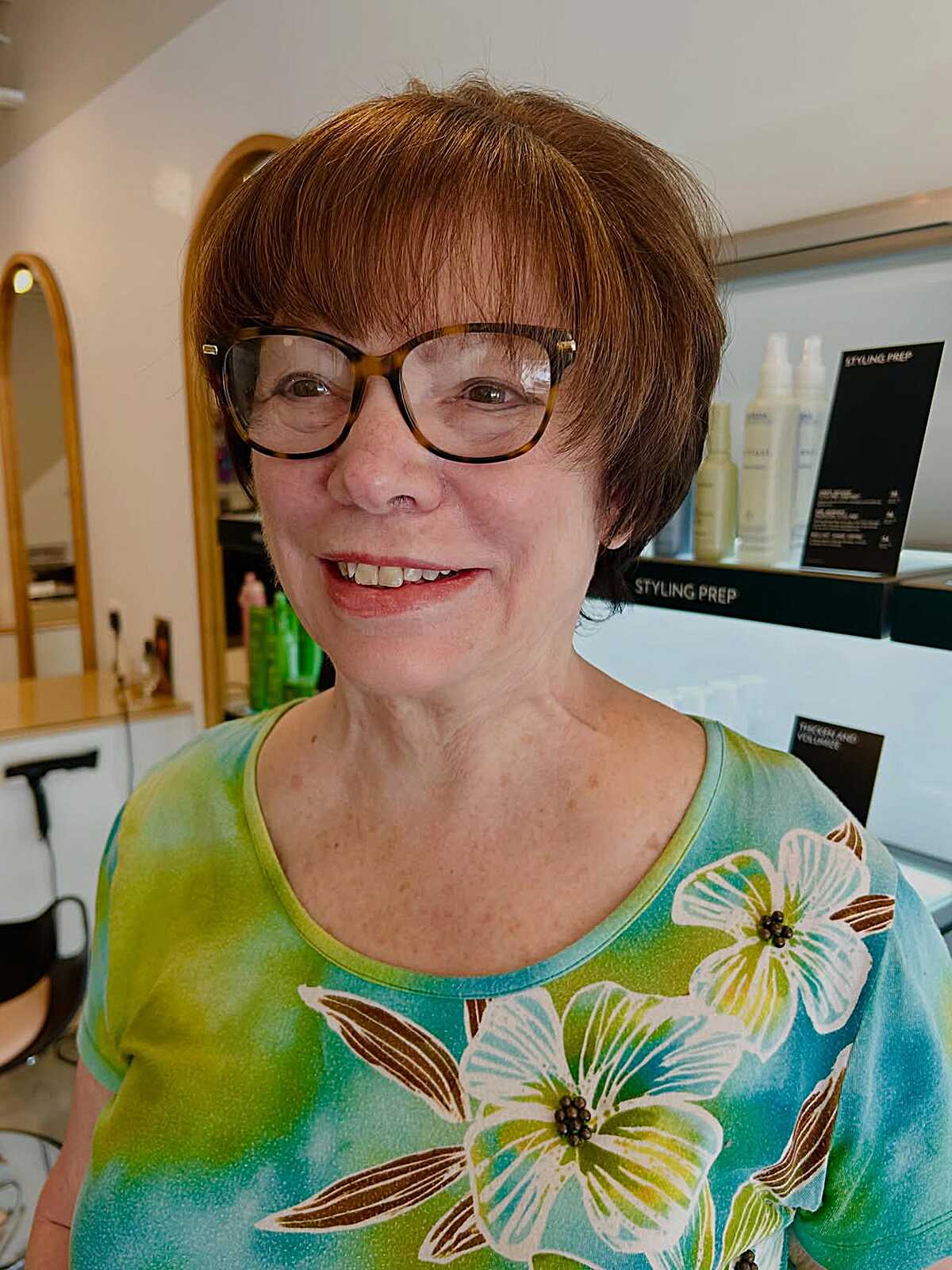 Auburn rounded pixie with bangs and glasses