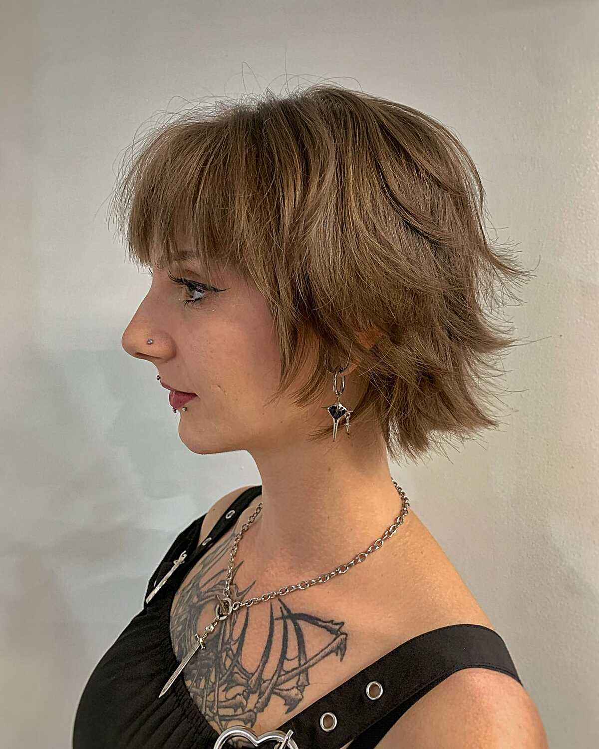 Short ash brown feathered shag bob with bangs