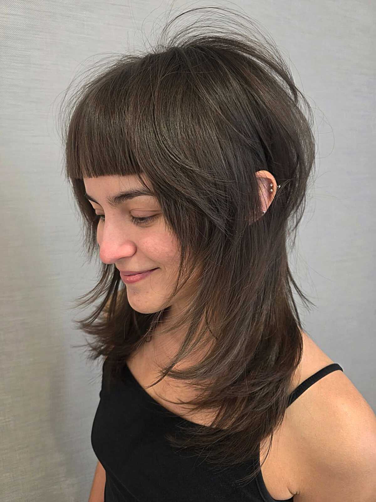 Medium ash brown feathered shag with bangs side view