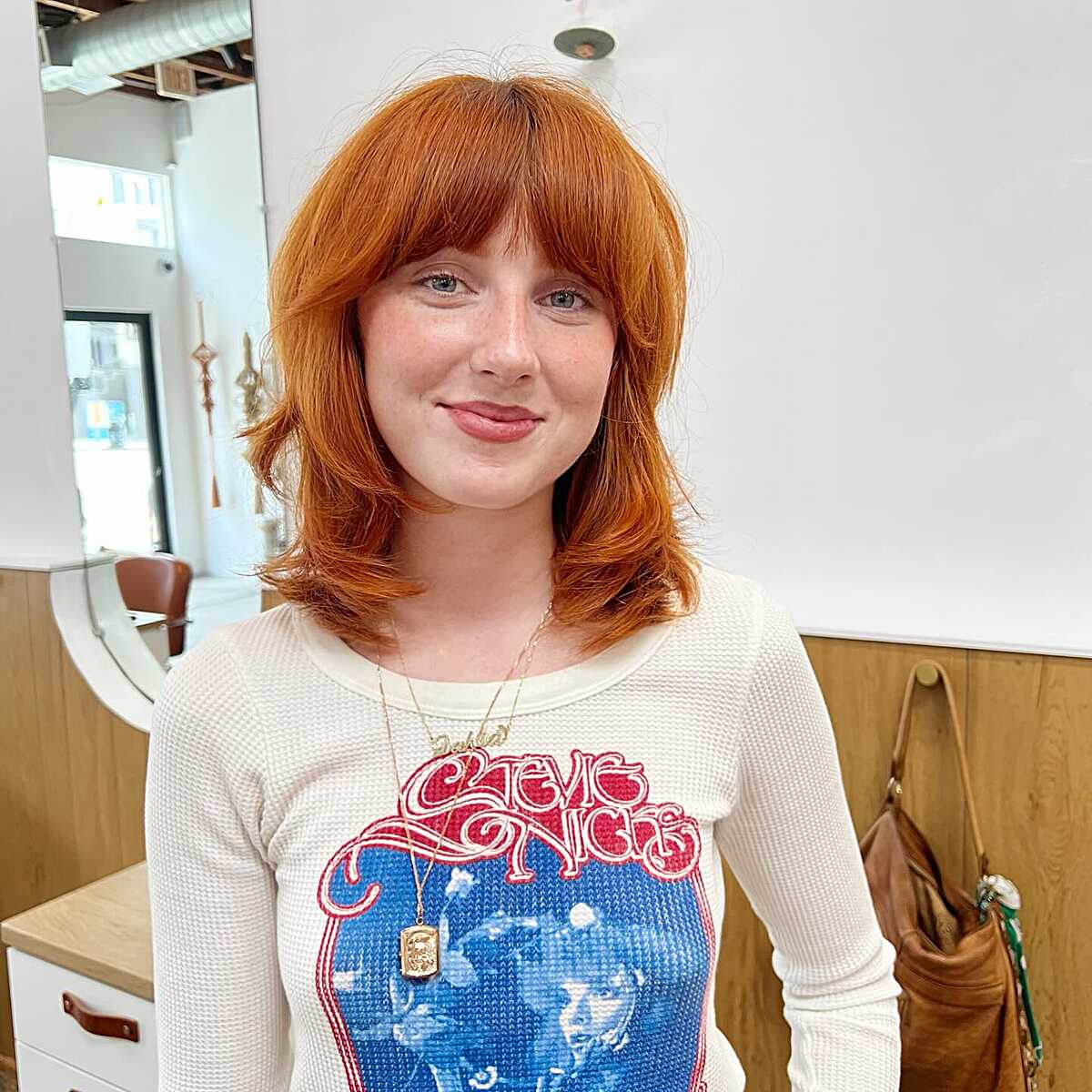 Bright ginger orange shoulder-length shag with bangs