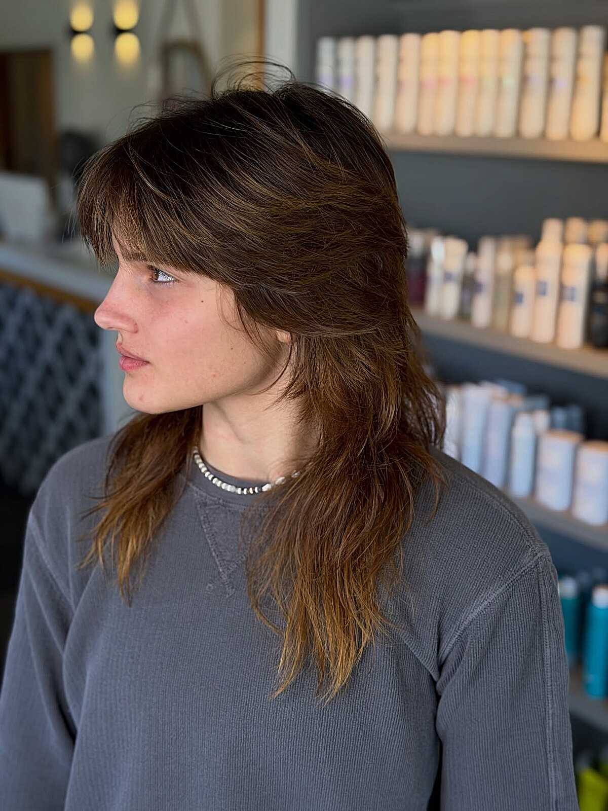 Long feathered brunette shag with heavy bangs